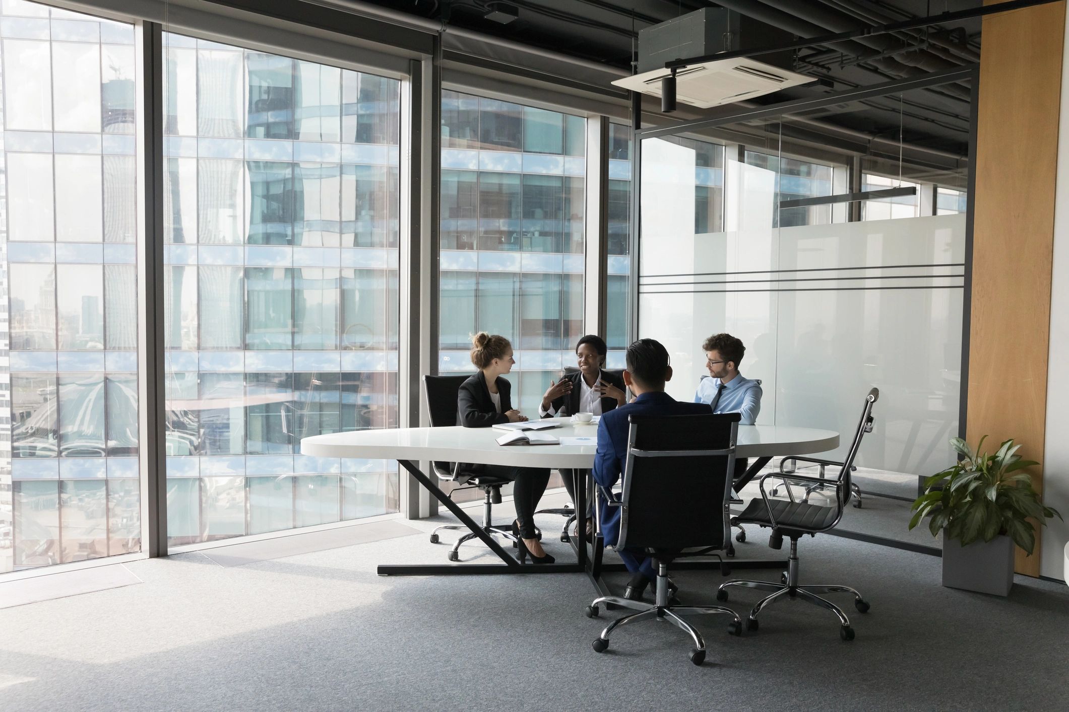 Modern business team in discussion around a meeting table