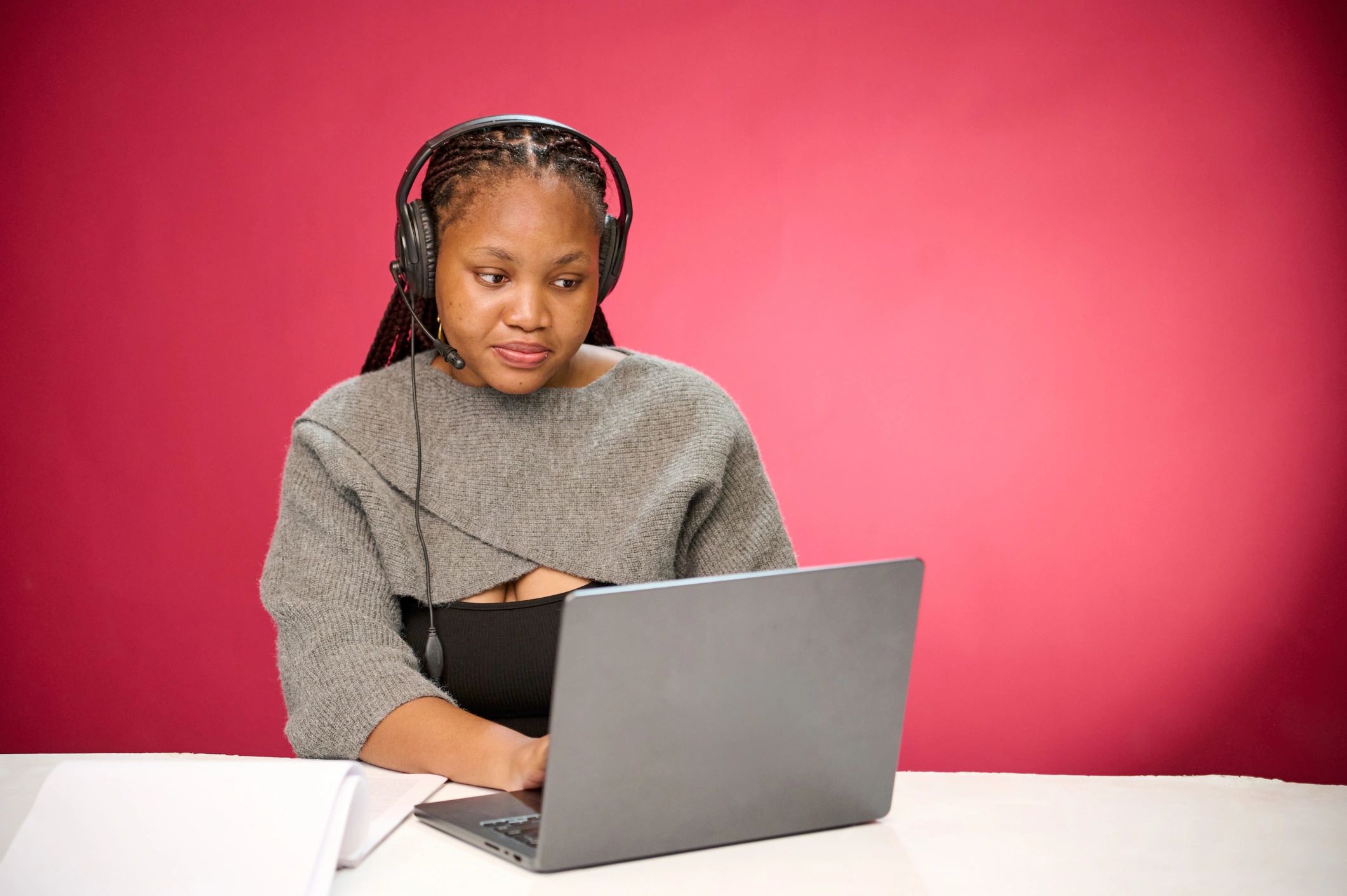 Professional using a laptop and headset to represent AI-powered customer support